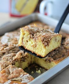 a close up of a tray of food with some cake on it and a cup in the background