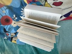 a stack of books sitting on top of a bed