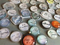 many different types of buttons with writing on them, all in various shapes and sizes