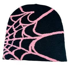 a black and pink beanie hat with spider web design on it's side