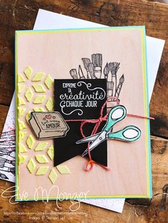 a close up of a card with scissors and other crafting supplies on top of it