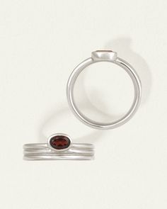 The Tana Ring is a solitaire ring crafted from recycled sterling silver with an oval garnet. Shop contemporary ring with offset silhouette. Gemstone Properties, Contemporary Ring, Diamond Guide, Garnet Ring, Ring Crafts, Garnet Rings, Engagement Ring Wedding Band, Recycled Sterling Silver, Ring Silver