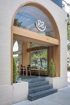 an entrance to a restaurant with steps leading up to the front door and outside seating area