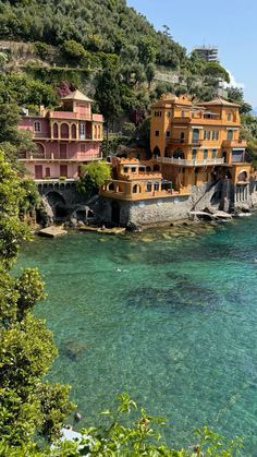 houses on the edge of a cliff overlooking water