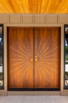 two wooden doors with sunburst designs on them