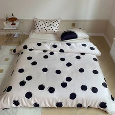 a bed with black and white polka dots on it