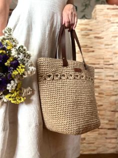 A large and elegant knitted jute bag with leather handles.. It is versatile and will suit many styles of clothing. You can also take it to the grocery store. A knitted bag will be a great gift for a girlfriend, wife or mother. The bag is made of natural jute material, so it has a special energy. Bag dimensions: 20*20*30 cm. Handle lengths: 50 cm Beige Crochet Bag With Leather Handles For Shopping, Casual Beige Crochet Bag With Braided Handles, Casual Beige Straw Bag With Leather Handles, Casual Cream Jute Bag, Beige Crochet Bag With Leather Handles For Daily Use, Neutral Straw Bag With Handles, Beige Crochet Shopping Bag With Braided Handles, Cream Crochet Bag With Leather Handles, Bohemian Jute Shoulder Bag For Shopping