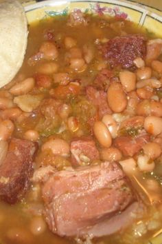 a plate filled with beans and meat on top of a table