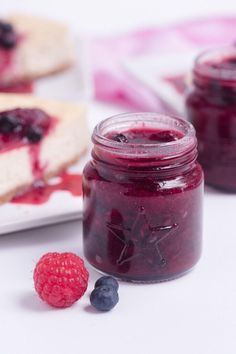 blueberry cheesecake and raspberry jam on a plate