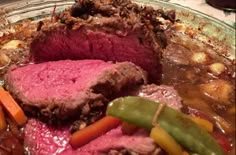 meat and vegetables are being cooked in a bowl