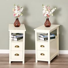 two white side tables with flowers on top