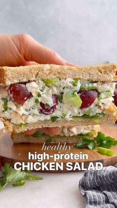 a hand holding a sandwich with chicken salad on it and the words healthy high protein chicken salad