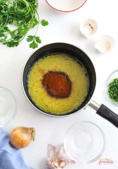 an overhead view of some food in a pan on a table next to other ingredients