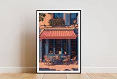 a framed photo of a restaurant with tables and chairs in front of the building's awnings