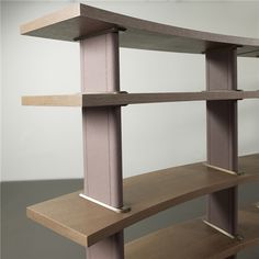 the shelf is made out of wood and has three shelves on each side, one with two