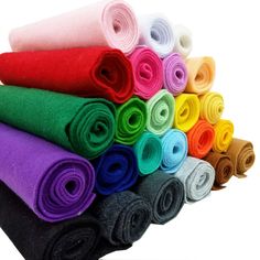 a pile of different colored towels sitting on top of each other