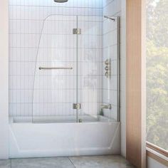 a bathroom with a walk in shower next to a window