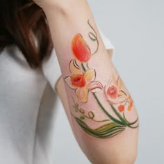 a woman with a flower tattoo on her arm