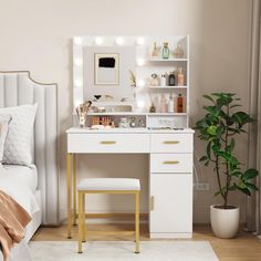 a white vanity with lights on it and a stool in front of the mirror, next to a potted plant