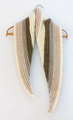 a knitted scarf hanging on a wooden hanger