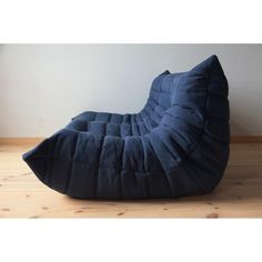 a blue bean bag chair sitting on top of a wooden floor