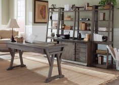 a living room filled with furniture and a large book shelf next to a desk in front of a window