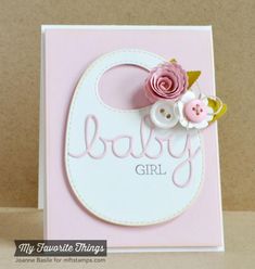 a baby girl card with pink flowers and a white bib on it's side