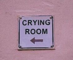 a sign on the side of a building that says crying room and an arrow pointing to the right