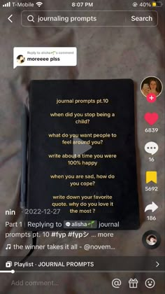 the journal is open and sitting on top of a bed next to a cell phone