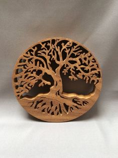 a wooden brooch with a tree on it