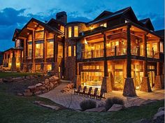 a large wooden house lit up at night