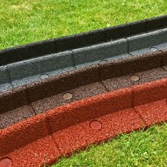 an arrangement of different colored bricks in the grass