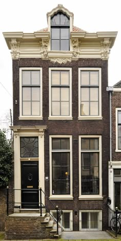 an old brick building with many windows and stairs