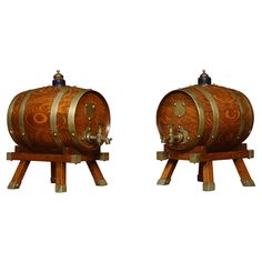 two wooden barrels sitting side by side on stands