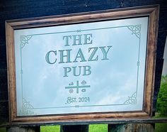 a sign that says the chazzy pub on it's side in front of some grass