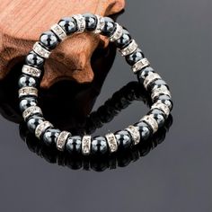 For a sparkling, yet understated addition to your collection, discover this strikingly beautiful Tibetan Silver Black Beaded Bracelet. Taking inspiration from the classic beaded bracelet, this piece features highly polished black stones spaced with Austrian Crystal bars. Providing an exceptional contrast and a stunning piece for a special occasion, this bracelet stretches to accommodate most wrist sizes and has a comfortable finish making it ideal for all day wear. Makes for a Great Gift idea! Bracelet length: 19cm Black bead size: 0.7cm Round Beaded Hematite Jewelry, Silver Crystal Bracelet With Black Beads, Elegant Adjustable Hematite Stretch Bracelet, Elegant Black Crystal Bracelet, Elegant Black Magnetic Bracelets, Elegant Black Beaded Bangle Bracelet, Silver Bracelets With Black Round Beads, Elegant Black Hematite Crystal Bracelet, Elegant Round Hematite Jewelry