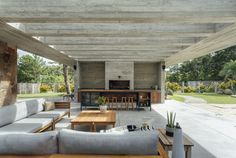 an outdoor living area with couches and tables