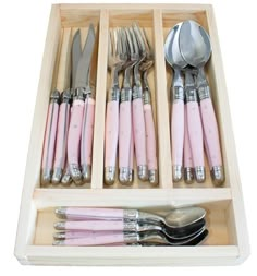 a drawer filled with silverware and pink utensils