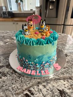 a birthday cake decorated with spongebob characters on top of a kitchen countertop