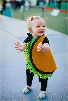 a toddler is dressed in a costume