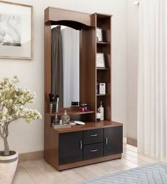 a bedroom with a large wooden cabinet next to a window and a potted plant