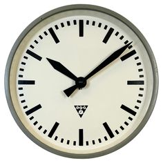 an analog clock with black hands on a white background