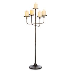 a tall metal candle holder with five lit candles