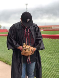 a man in a baseball cap and glove is standing on the field with his back to the camera