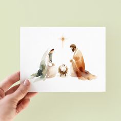 a hand holding up a card with three wise men and the star of david on it