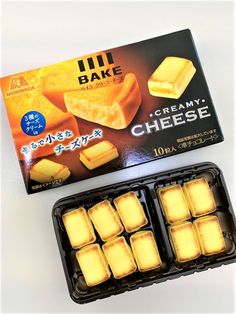 an open box of ice cream with cubes in it next to some other boxes