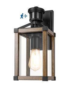 an outdoor light fixture with a wooden frame and clear glass on the front, which is attached