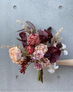 a bouquet of flowers sitting on top of a wall