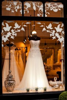 an image of a window with wedding dresses on display