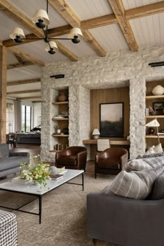 a living room filled with furniture and stone walls